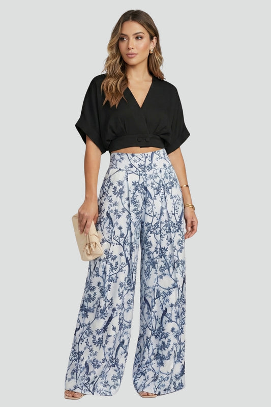 Women’s black two-piece set with V-neck top and wide-leg trousers from THE WHITMORE FAMILY, styled on a model.