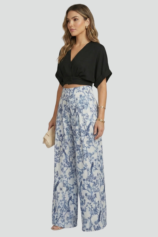 Black women’s two-piece set with V-neck top and wide-leg trousers from THE WHITMORE FAMILY, styled for a casual look.