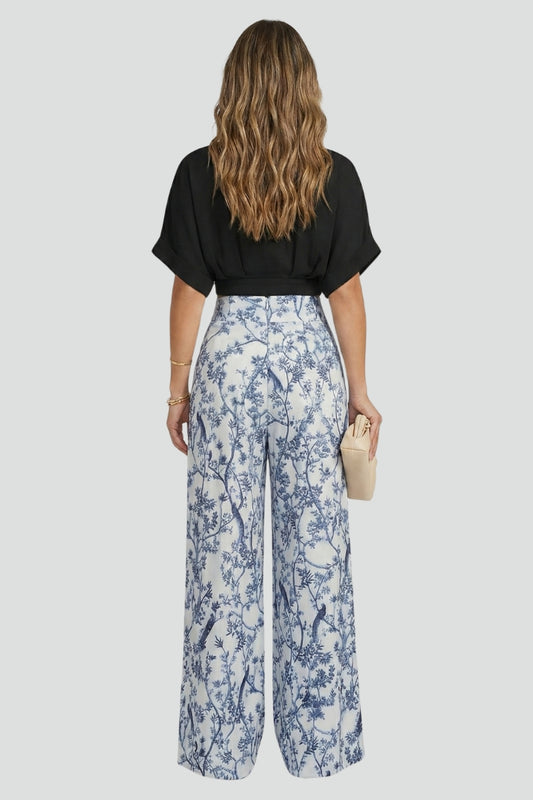 Women's two-piece set by THE WHITMORE FAMILY featuring a black V-neck top and wide-leg trousers, casual and stylish for everyday wear.