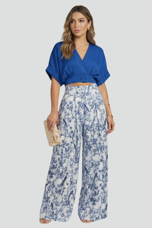 Women’s black two-piece set with V-neck top and wide-leg trousers by THE WHITMORE FAMILY, shown on a model.