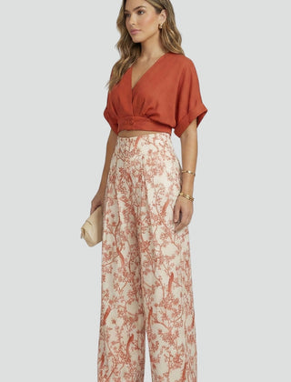 Women’s black two-piece set with V-neck top and wide-leg trousers from THE WHITMORE FAMILY, casual stylish women's outfit.
