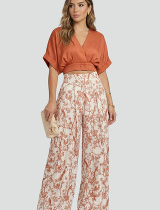 Women’s black two-piece set by THE WHITMORE FAMILY featuring a V-neck top and wide-leg trousers, styled on a model.