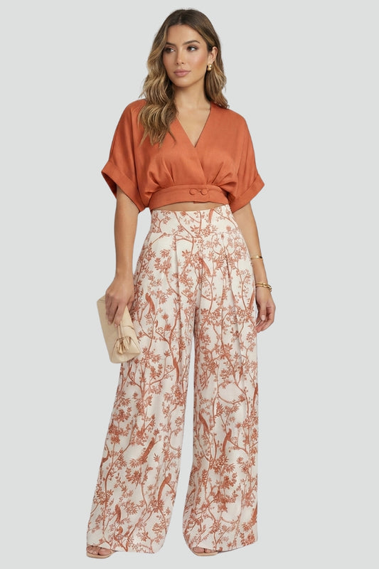 Women’s black two-piece set by THE WHITMORE FAMILY featuring a V-neck top and wide-leg trousers, styled on a model.