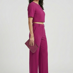 Women’s two-piece set with short sleeve top and wide-leg trousers from THE WHITMORE FAMILY, styled for casual or office wear.
