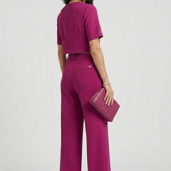 Women’s two-piece set by THE WHITMORE FAMILY featuring a short sleeve top and wide-leg trousers, stylish and comfortable for casual wear.