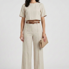 Women’s two-piece set with short sleeve top and wide-leg trousers by THE WHITMORE FAMILY, shown in a stylish, casual outfit.