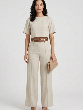 Women’s two-piece set with short sleeve top and wide-leg trousers by THE WHITMORE FAMILY, shown in a stylish, casual outfit.