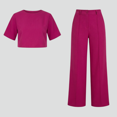 Women’s two-piece set featuring a short sleeve top and wide-leg trousers by THE WHITMORE FAMILY, shown in a stylish, casual outfit.