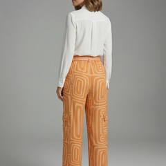 Women’s shirt and trousers set by THE WHITMORE FAMILY, featuring a button closure and straight-leg design, stylish and comfortable.