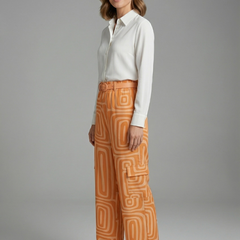 Women’s shirt and trousers set with button closure and straight-leg design by THE WHITMORE FAMILY, shown in stylish fabric.