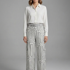 Women’s shirt and trousers set by THE WHITMORE FAMILY featuring button closure and straight-leg design, shown in neutral fabric.