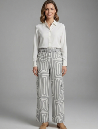 Women’s shirt and trousers set by THE WHITMORE FAMILY featuring button closure and straight-leg design, shown in neutral fabric.