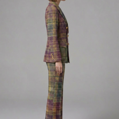 Women’s suit set featuring a double-breasted blazer and wide-leg trousers by THE WHITMORE FAMILY, shown on a model.