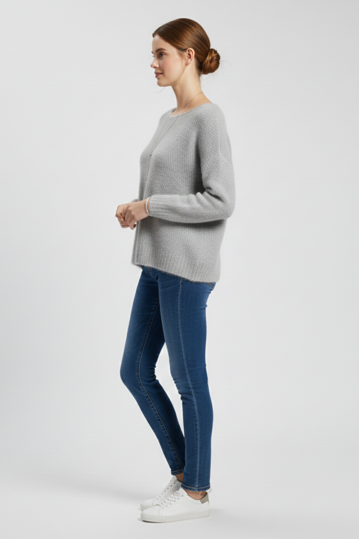 Women’s sweater by THE WHITMORE FAMILY featuring a wide neckline and soft brushed knit surface, styled with long sleeves.