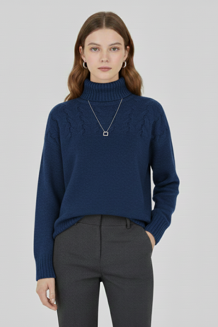 Women’s sweater with turtleneck and textured cable pattern by THE WHITMORE FAMILY, showing a cozy knit design in neutral tones.