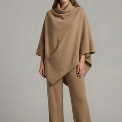 Women’s black top and trousers set by THE WHITMORE FAMILY featuring a high neck and wide sleeves, stylish and comfortable ensemble.