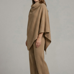 Women’s black top and trousers set with high neck and wide sleeves by THE WHITMORE FAMILY, shown on a model.