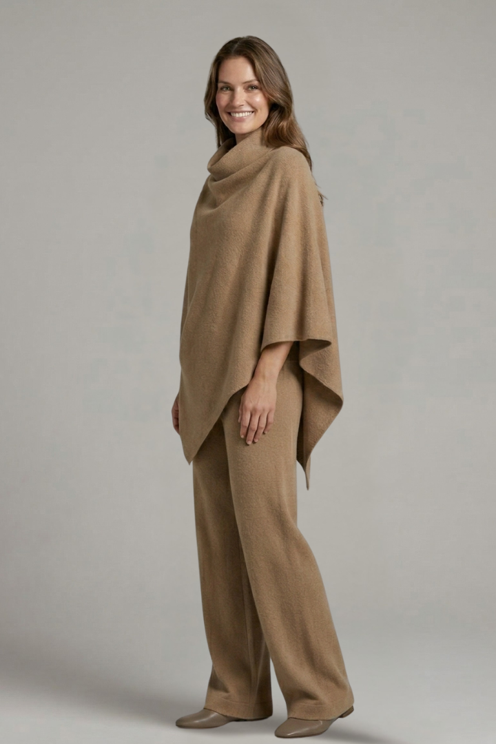 Women’s black top and trousers set with high neck and wide sleeves by THE WHITMORE FAMILY, shown on a model.