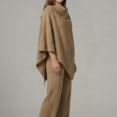 Black women’s top and trousers set by THE WHITMORE FAMILY with a high neck and wide sleeves, shown on a model.