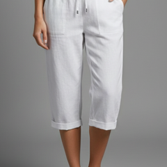 Beige women's knee-length trousers with high-waisted fit and straight legs from THE WHITMORE FAMILY, shown on a model.