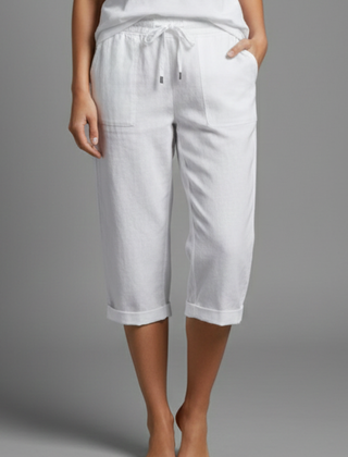Beige women's knee-length trousers with high-waisted fit and straight legs from THE WHITMORE FAMILY, shown on a model.