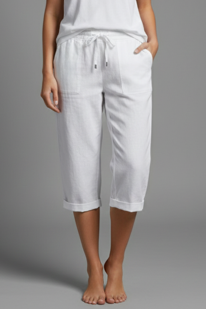 Beige women's knee-length trousers with high-waisted fit and straight legs from THE WHITMORE FAMILY, shown on a model.