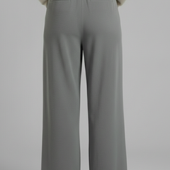 Beige women's palazzo trousers with tie waist from THE WHITMORE FAMILY, featuring wide legs and relaxed fit.