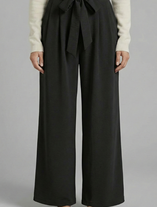 Beige women's palazzo trousers with tie waist and relaxed fit, stylish women's trousers by THE WHITMORE FAMILY.
