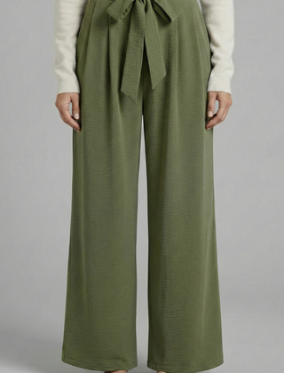 Beige women’s palazzo trousers with tie waist from THE WHITMORE FAMILY, flowing wide-leg style, perfect for casual or dressy looks.