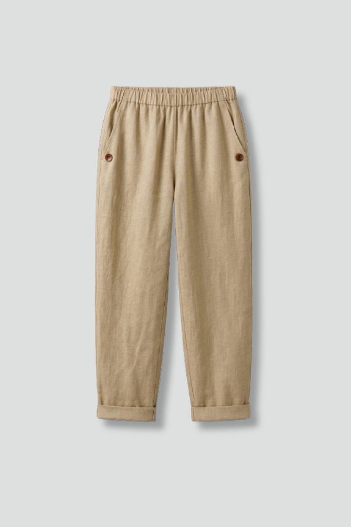 Beige women’s trousers from THE WHITMORE FAMILY featuring an elastic waistband and side pockets, shown on a model.