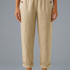 Beige women's trousers with elastic waistband and side pockets from THE WHITMORE FAMILY, casual and comfortable fit.
