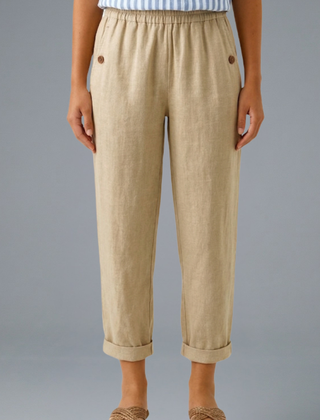 Beige women's trousers with elastic waistband and side pockets from THE WHITMORE FAMILY, casual and comfortable fit.