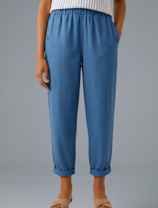 Beige women's trousers by THE WHITMORE FAMILY with elastic waistband and side pockets, casual and comfortable fit.