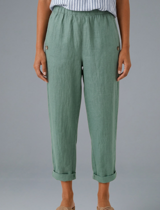 Beige women’s trousers with elastic waistband and side pockets from THE WHITMORE FAMILY, casual and comfortable fit.