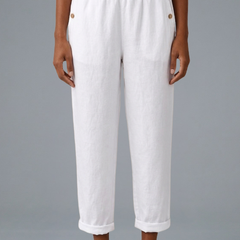 Beige women’s trousers with elastic waistband and side pockets from THE WHITMORE FAMILY, shown on a model.