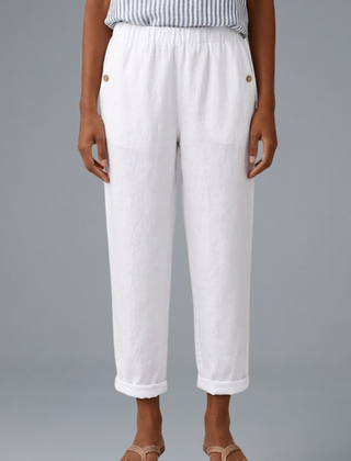 Beige women’s trousers with elastic waistband and side pockets from THE WHITMORE FAMILY, shown on a model.