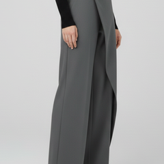 Women’s trousers by THE WHITMORE FAMILY with asymmetric front design and straight-leg cut, shown in a neutral fabric and fit.