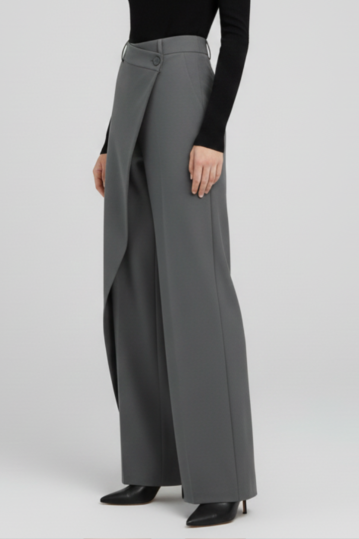 Women's trousers with asymmetric front design and straight legs by THE WHITMORE FAMILY, shown on a model.