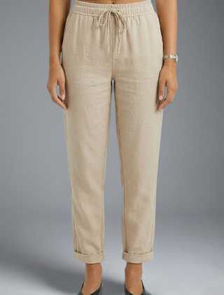 Women’s trousers with elasticated waistband and drawstring, by THE WHITMORE FAMILY, featuring a comfortable and relaxed fit.