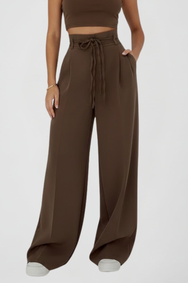 Women’s wide leg trousers with tie waist and high rise from THE WHITMORE FAMILY, showing the stylish fit and fabric texture.