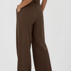 Women’s wide leg trousers with tie waist and high rise, stylish women's trousers by THE WHITMORE FAMILY, shown in natural fabric.