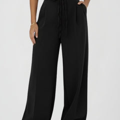 Women’s wide leg trousers with tie waist and high rise from THE WHITMORE FAMILY, shown with relaxed fit and stylish design.
