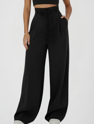 Women’s wide leg trousers with tie waist and high rise from THE WHITMORE FAMILY, shown with relaxed fit and stylish design.