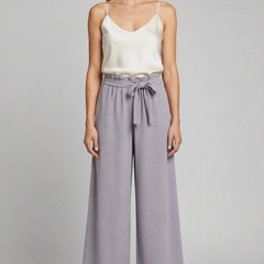 Women’s wide-leg trousers with tie waist from THE WHITMORE FAMILY, featuring a relaxed fit and stylish design.