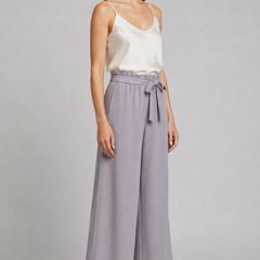 Women’s wide-leg trousers with tie waist from THE WHITMORE FAMILY, featuring a relaxed fit and stylish design.