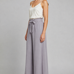 Women's trousers with tie waist and wide-leg design by THE WHITMORE FAMILY, shown in a relaxed fit with a flattering silhouette.
