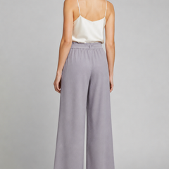 Women’s wide-leg trousers with tie waist in beige, featuring relaxed fit and stylish design by THE WHITMORE FAMILY.
