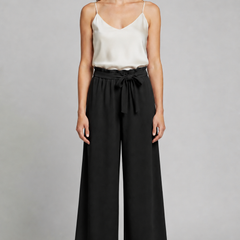 Women's trousers by THE WHITMORE FAMILY with tie waist and wide-leg design, shown in a stylish, relaxed fit.