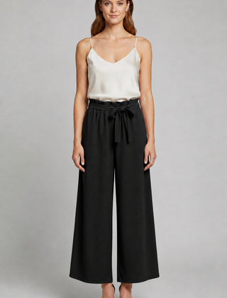 Women's trousers by THE WHITMORE FAMILY with tie waist and wide-leg design, shown in a stylish, relaxed fit.