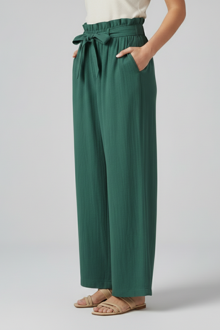 Green women’s trousers with elastic waist and tie belt by THE WHITMORE FAMILY, shown on a model.